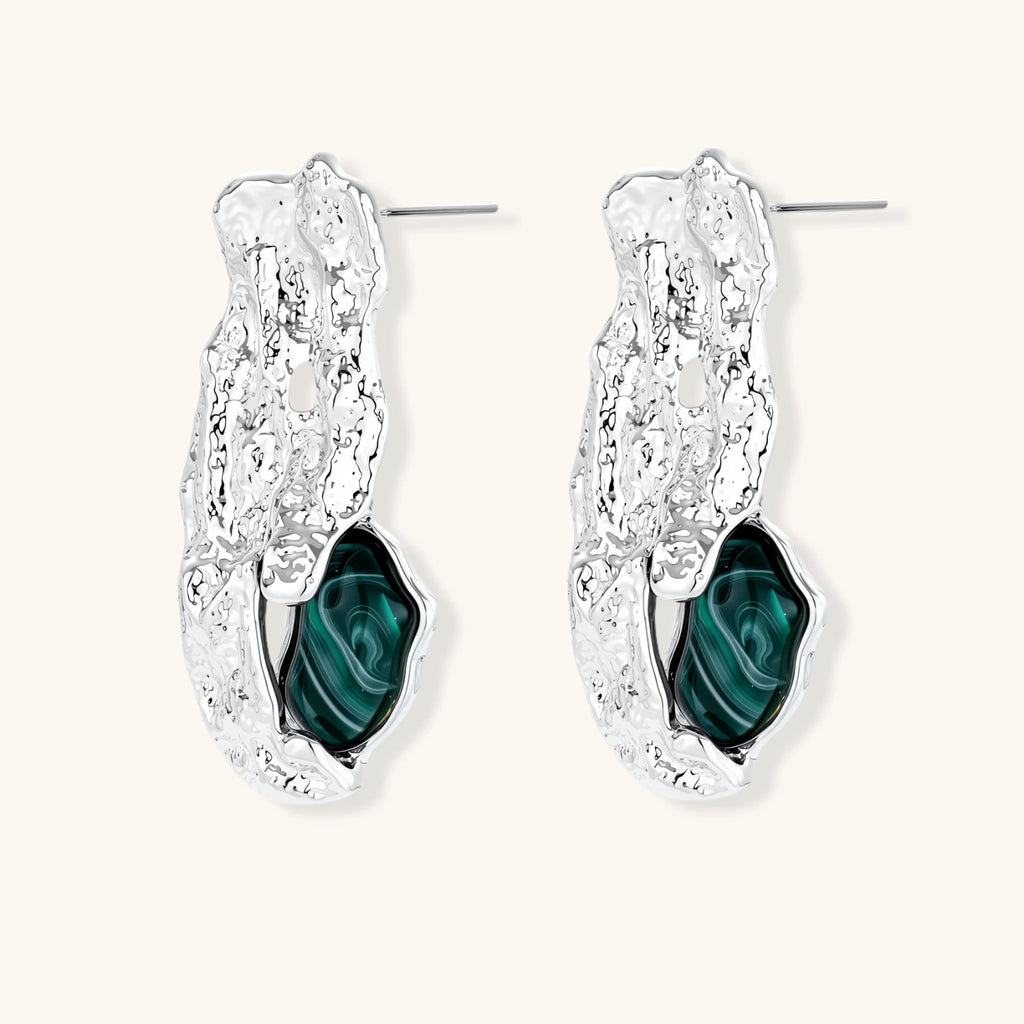 Organic-shaped stud earrings with hammered silver finish and green malachite-pattern resin stones on white background.